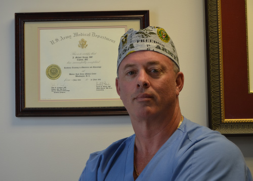 Dr. J Michael Knapp in front of a U.S. Army Medical Department Certificate